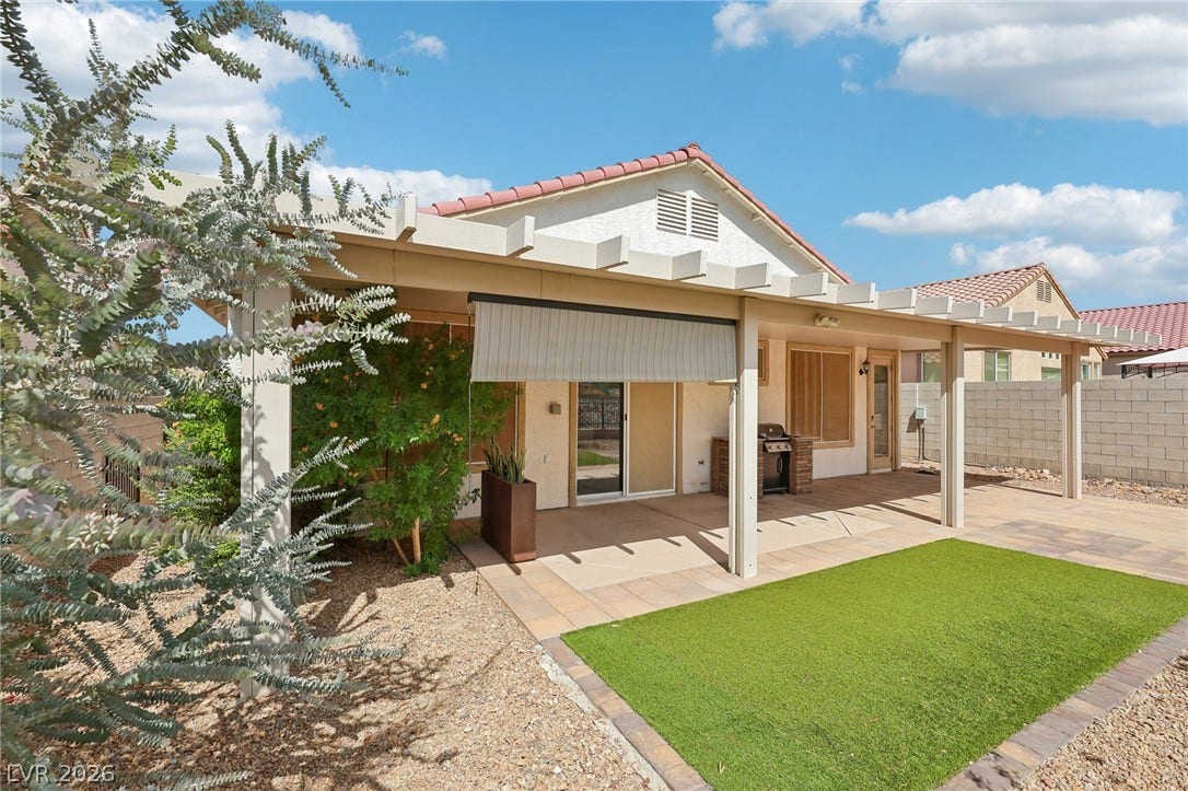 3027 Panorama Ridge Drive, Henderson, NV 89052 A spacious covered patio overlooks the synthetic lawn and desert landscaping.