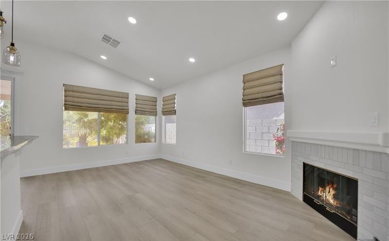 3027 Panorama Ridge Drive, Henderson, NV 89052 An inviting fireplace anchor this open living area finished with smooth plank flooring.