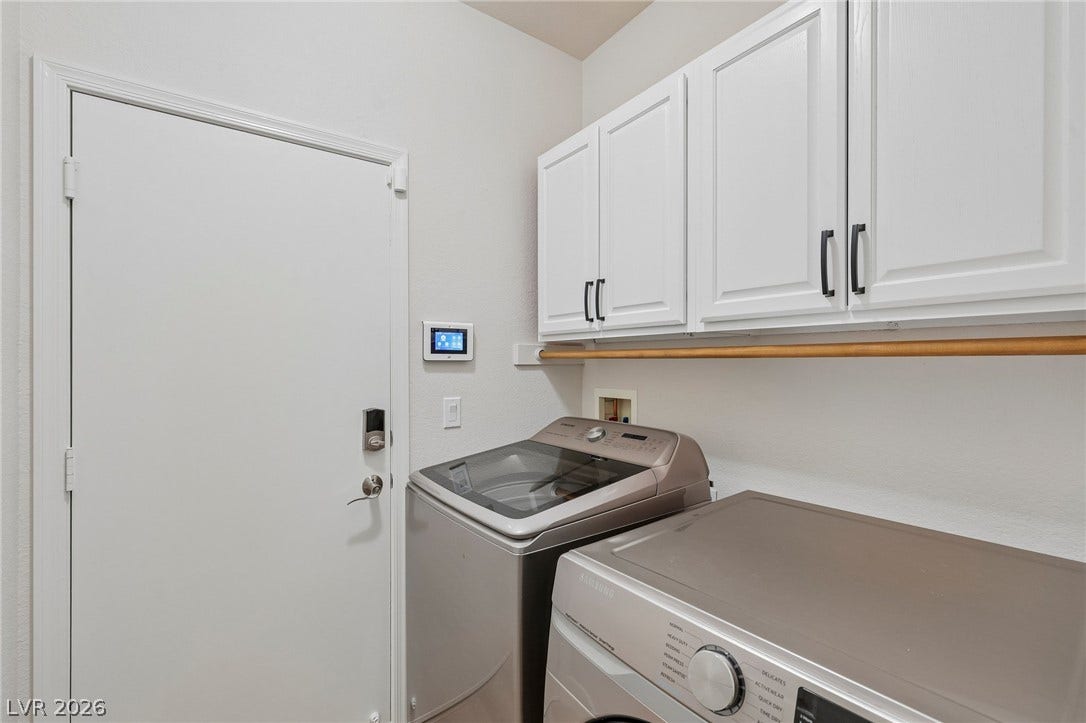3027 Panorama Ridge Drive, Henderson, NV 89052 White cabinetry and overhead hanging space maximize storage in this functional utility area.