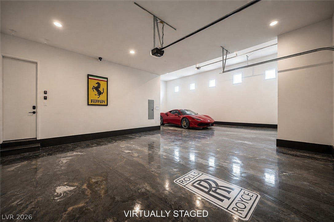 3904 Aiden Creek Avenue, North Las Vegas, NV 89031 Polished epoxy floors and high ceilings define this expansive multi-car showroom garage.