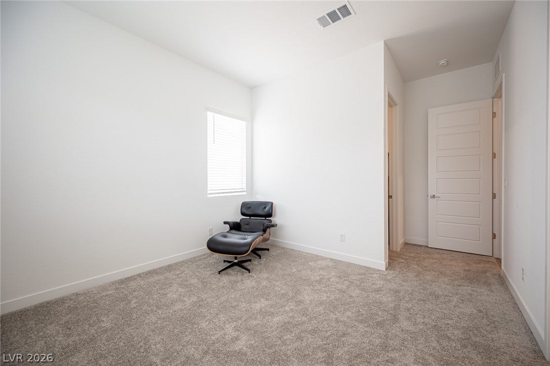 3904 Aiden Creek Avenue, North Las Vegas, NV 89031 Plush carpeting and crisp white walls create a serene, minimalist retreat.