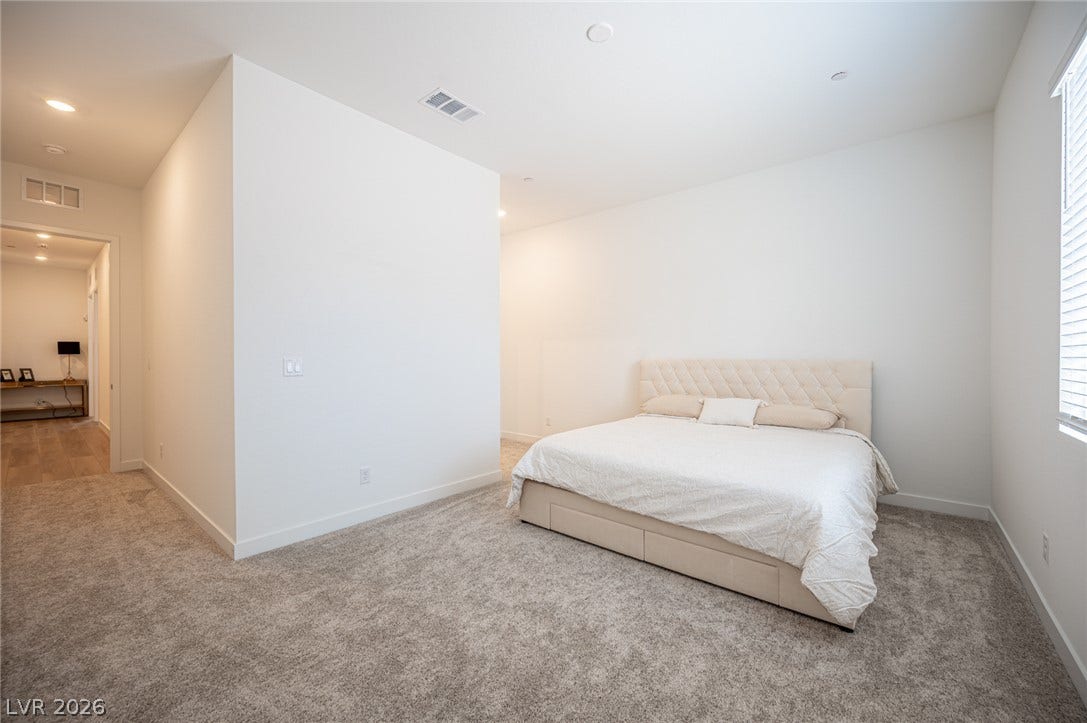 3904 Aiden Creek Avenue, North Las Vegas, NV 89031 Soft carpeting underfoot defines this serene sleeping space with clean lines and recessed lighting.