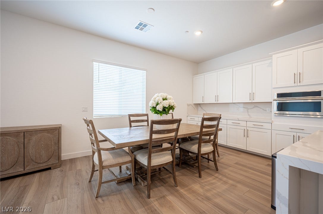 3904 Aiden Creek Avenue, North Las Vegas, NV 89031 Warm wood flooring and clean cabinetry define this versatile dining space.