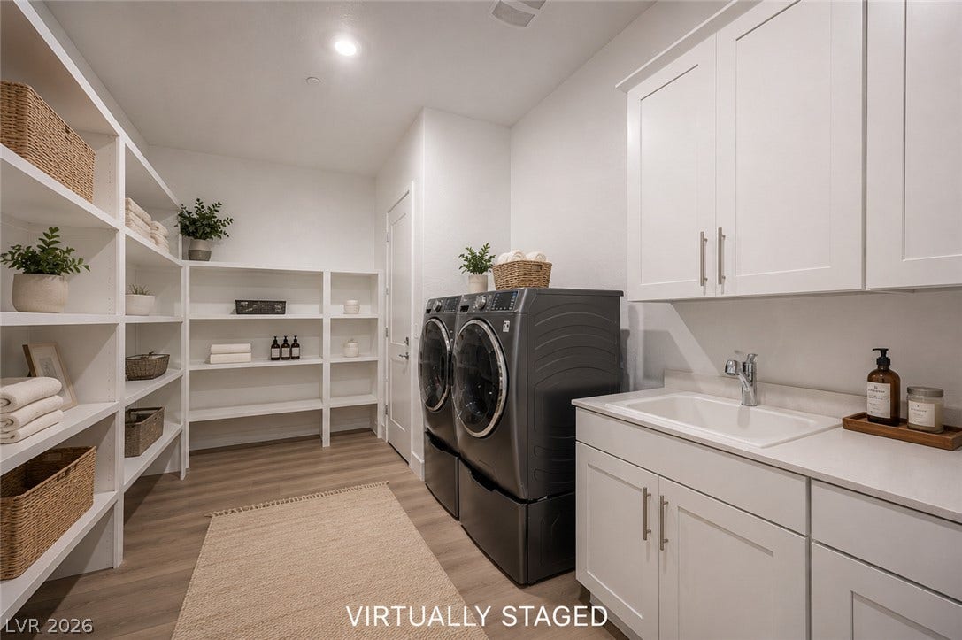 3904 Aiden Creek Avenue, North Las Vegas, NV 89031 Ample built-in shelving and a practical utility sink elevate this functional laundry space.