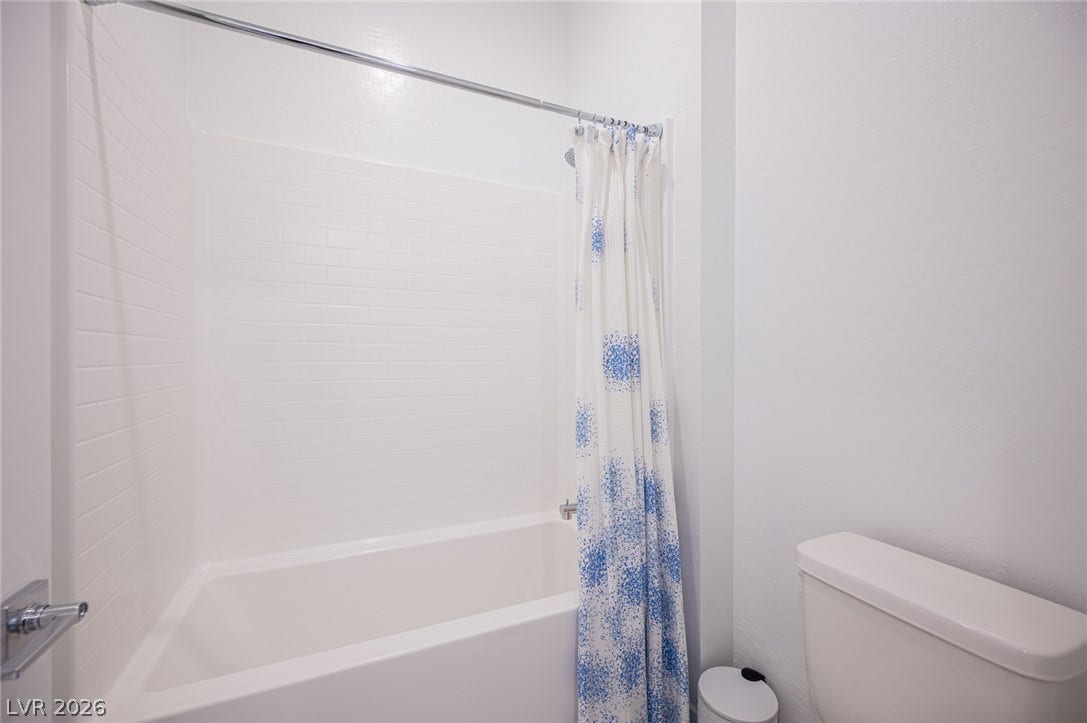 3904 Aiden Creek Avenue, North Las Vegas, NV 89031 A clean tiled tub surround defines this functional bathroom space.