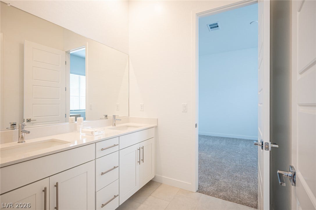 3904 Aiden Creek Avenue, North Las Vegas, NV 89031 Clean lines and a spacious dual vanity highlight this contemporary bathroom design.