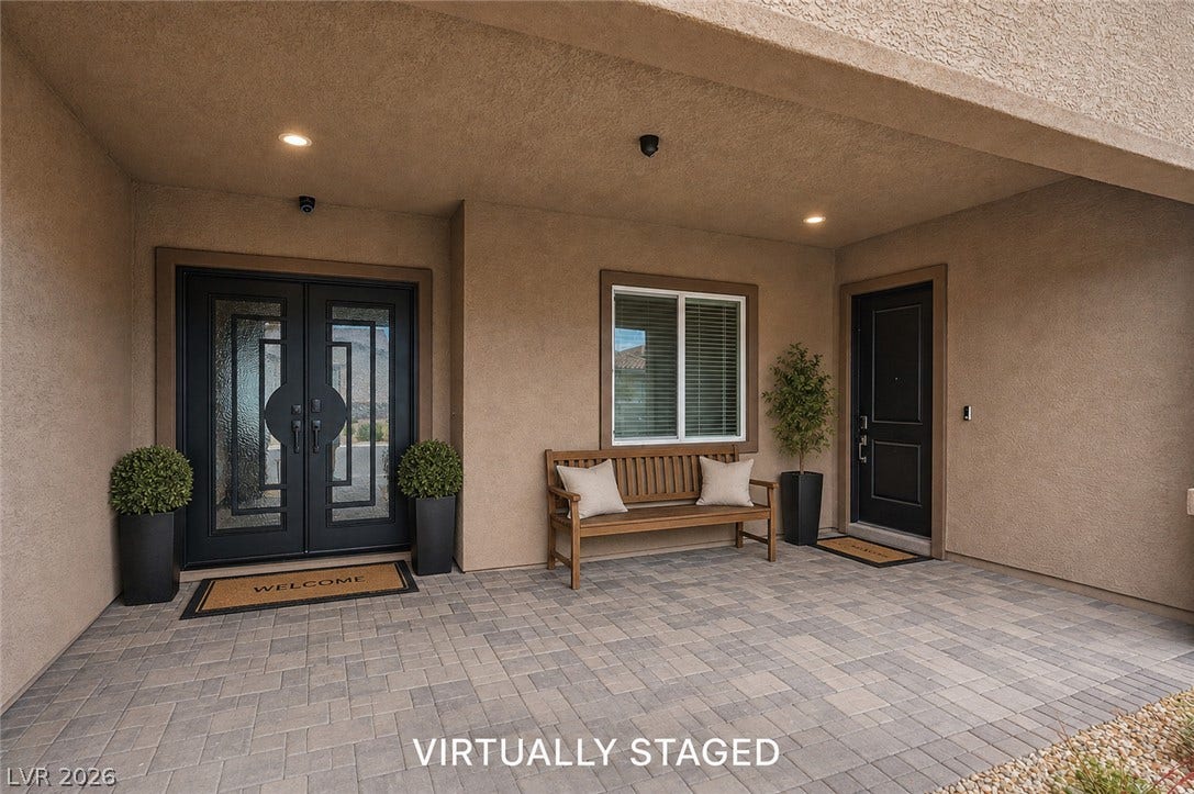 3904 Aiden Creek Avenue, North Las Vegas, NV 89031 An inviting covered entryway features handsome stone pavers and glass-paned double doors.