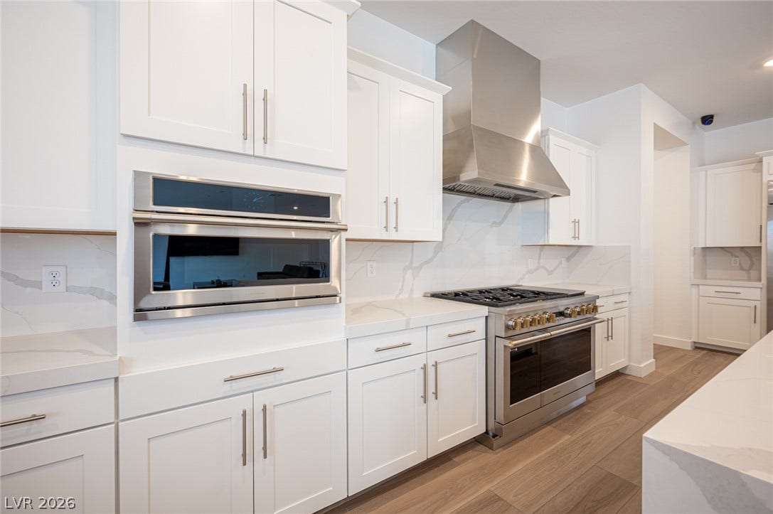 3904 Aiden Creek Avenue, North Las Vegas, NV 89031 Sleek modern cabinetry and premium stainless appliances anchor this beautifully designed culinary space.