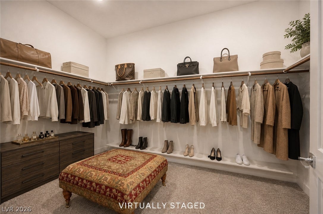 3904 Aiden Creek Avenue, North Las Vegas, NV 89031 Ample built-in shelving and custom hanging rods define this spacious carpeted dressing area.
