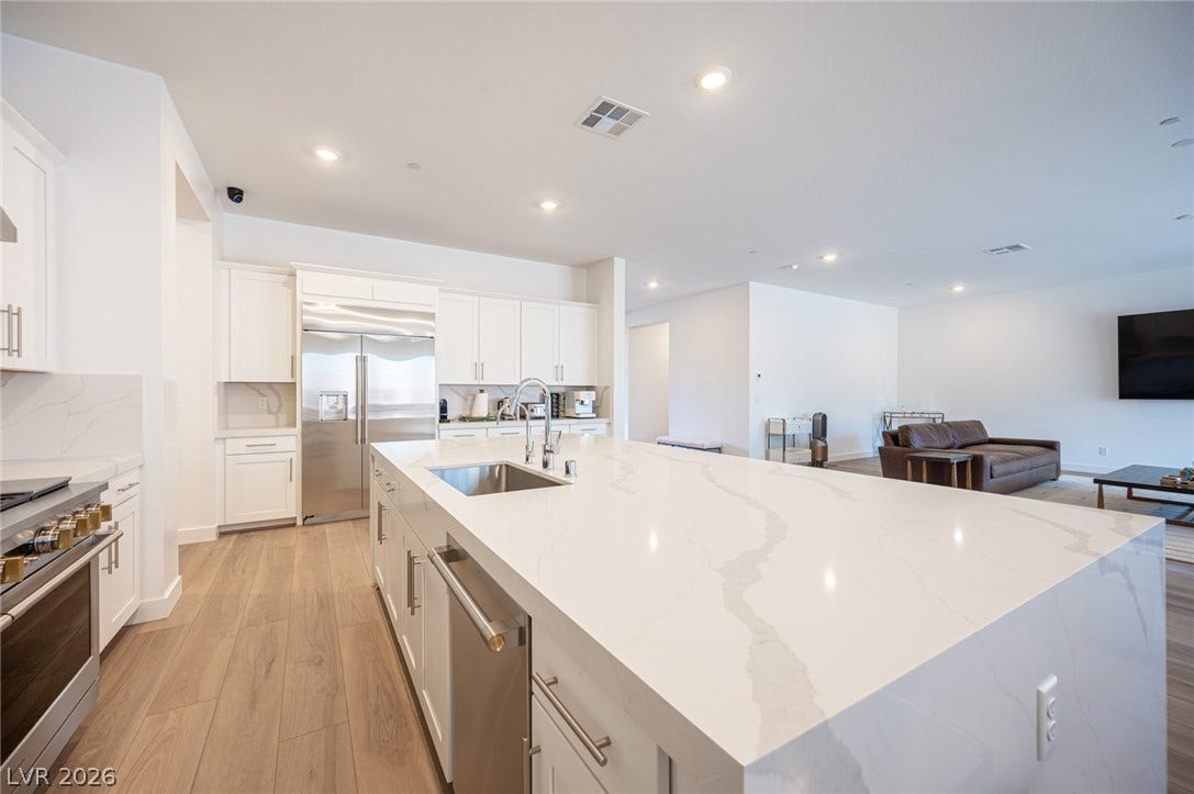3904 Aiden Creek Avenue, North Las Vegas, NV 89031 An open floor plan seamlessly connects the gourmet kitchen to the main living area.