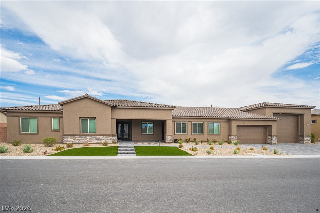 3904 Aiden Creek Avenue, North Las Vegas, NV 89031 Stone accents and a tiled roof enhance the exterior of this single-level home.