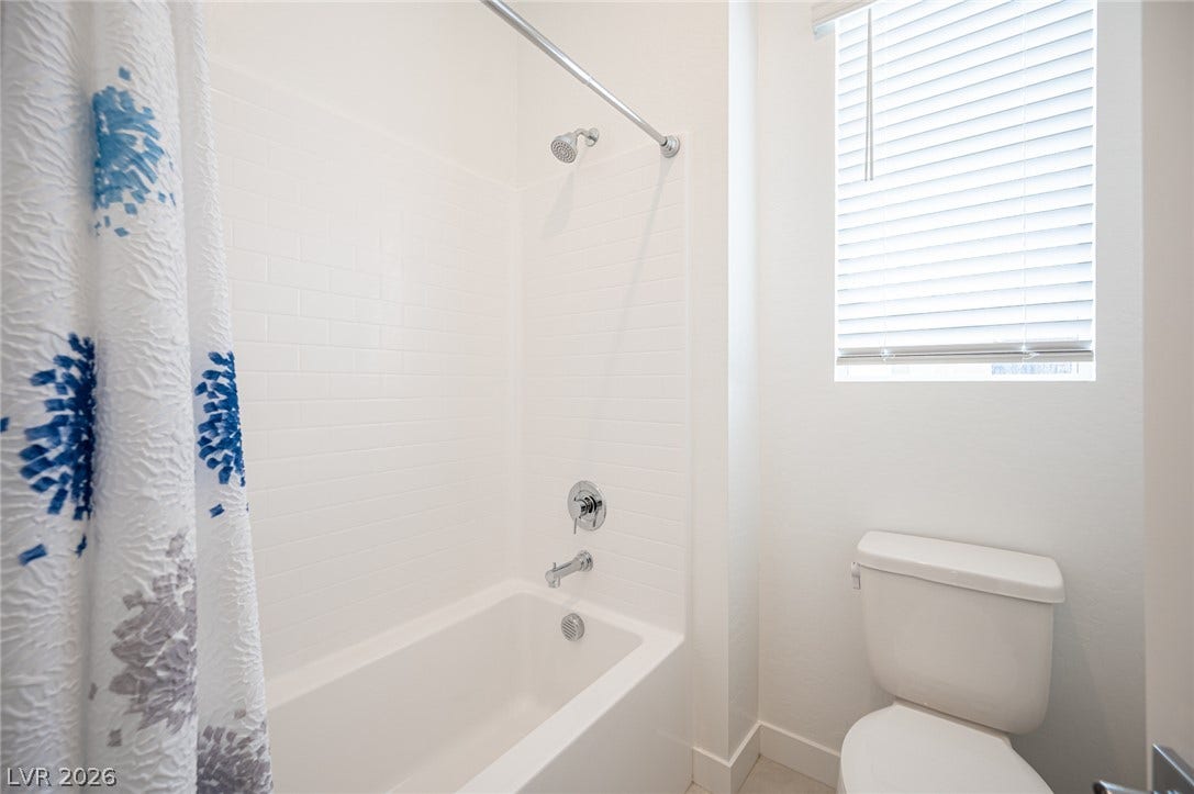 3904 Aiden Creek Avenue, North Las Vegas, NV 89031 Clean lines and a tiled shower-tub combination define this functional bathroom space.