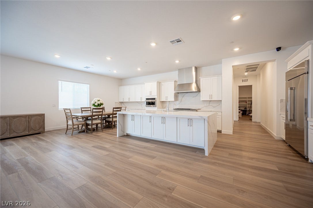 3904 Aiden Creek Avenue, North Las Vegas, NV 89031 Gleaming wood-look floors anchor this airy culinary space with a waterfall-edge center island.