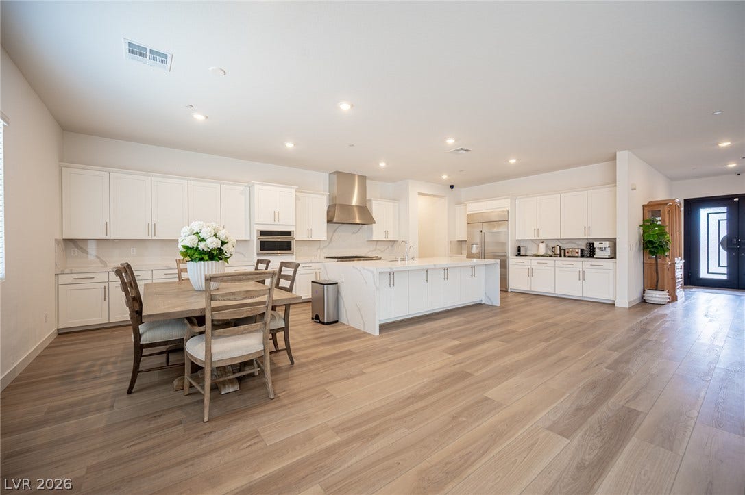 3904 Aiden Creek Avenue, North Las Vegas, NV 89031 Rich wood-plank flooring flows through this expansive culinary space and adjoining dining area.