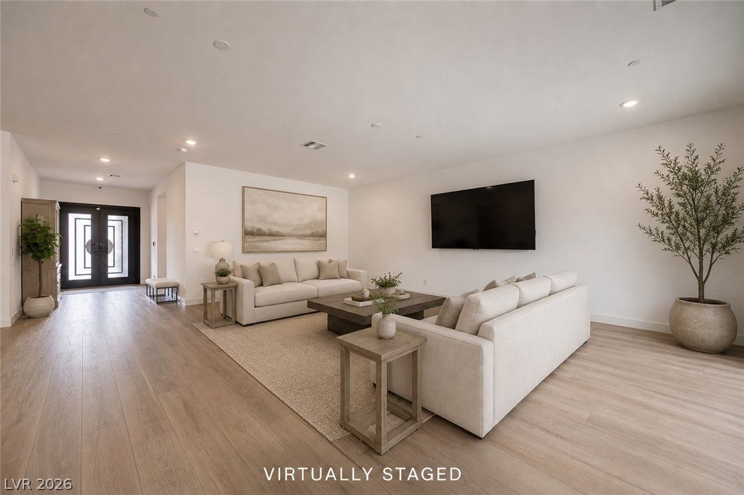 3904 Aiden Creek Avenue, North Las Vegas, NV 89031 Smooth wood floors flow effortlessly through this wide, open living space.