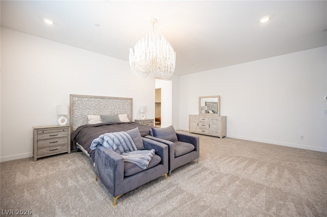 3904 Aiden Creek Avenue, North Las Vegas, NV 89031 A spacious bedroom features plush carpeting and recessed lighting.