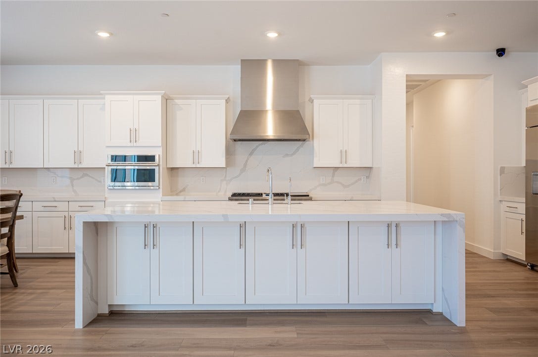 3904 Aiden Creek Avenue, North Las Vegas, NV 89031 An oversized center island anchors this modern kitchen with premium stone countertops.