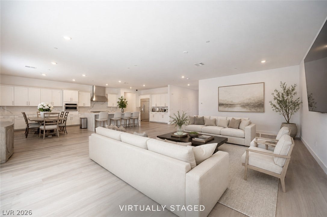 3904 Aiden Creek Avenue, North Las Vegas, NV 89031 Smooth wood floors flow seamlessly through this expansive, open-concept living area and kitchen.
