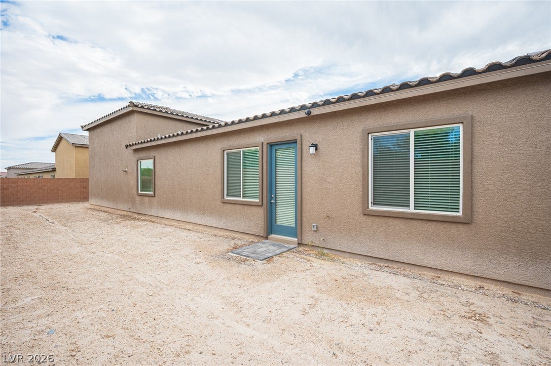3904 Aiden Creek Avenue, North Las Vegas, NV 89031 A spacious desert yard borders the stucco exterior of this modern single-story residence.