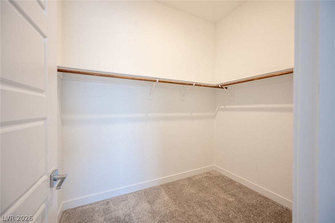 3904 Aiden Creek Avenue, North Las Vegas, NV 89031 Ample hanging rods and neutral carpeting define this functional storage space.