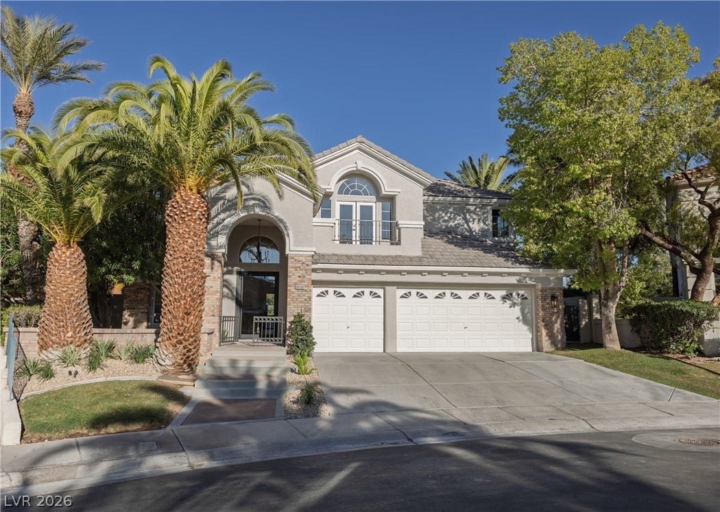 8800 Lusso Court, Las Vegas, NV 89134 View of front of property with an attached garage, concrete driveway, stucco siding, brick siding, and french doors