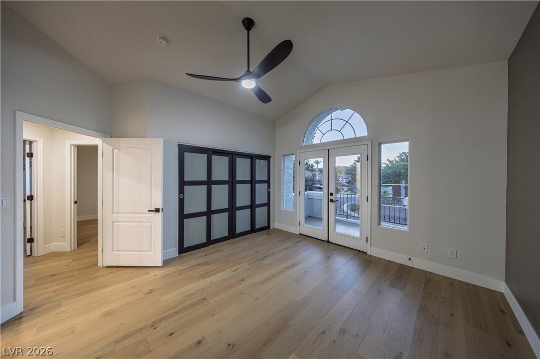 8800 Lusso Court, Las Vegas, NV 89134 Unfurnished bedroom featuring vaulted ceiling, light wood-type flooring, a ceiling fan, and access to outside
