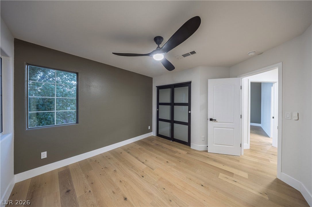 8800 Lusso Court, Las Vegas, NV 89134 Unfurnished bedroom featuring light wood-style floors, ceiling fan, and a closet