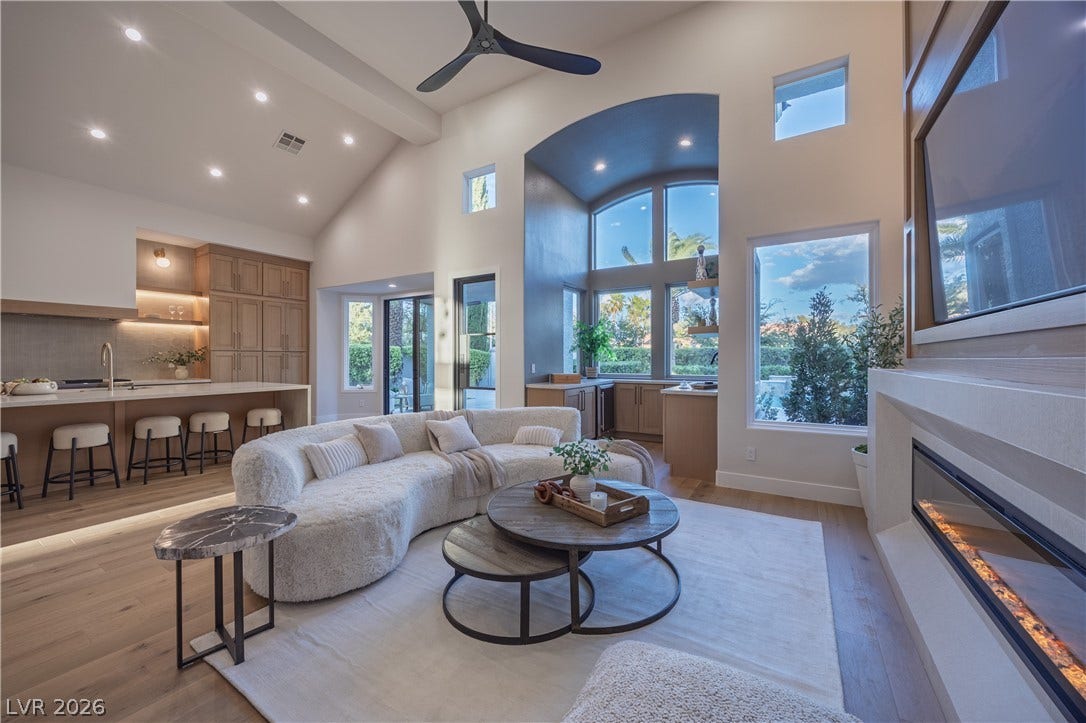 8800 Lusso Court, Las Vegas, NV 89134 Living area featuring light wood-style floors, a glass covered fireplace, plenty of natural light, recessed lighting, and ceiling fan