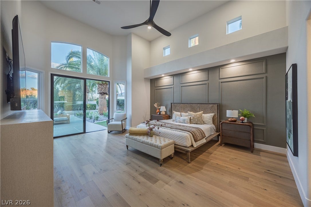 8800 Lusso Court, Las Vegas, NV 89134 Bedroom featuring light wood-type flooring, a high ceiling, access to exterior, ceiling fan, and recessed lighting