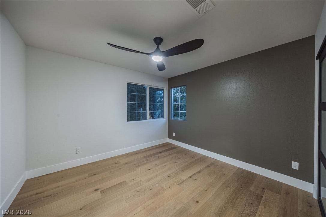 8800 Lusso Court, Las Vegas, NV 89134 Empty room with light wood-style floors and a ceiling fan