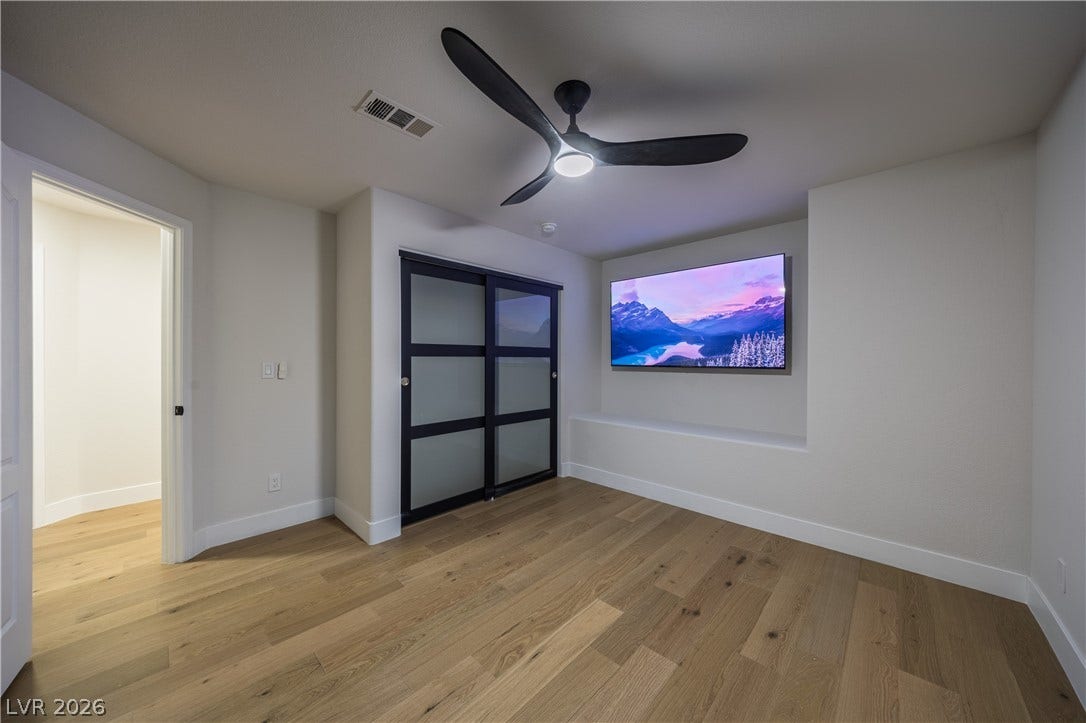 8800 Lusso Court, Las Vegas, NV 89134 Unfurnished bedroom featuring light wood finished floors, ceiling fan, and a closet