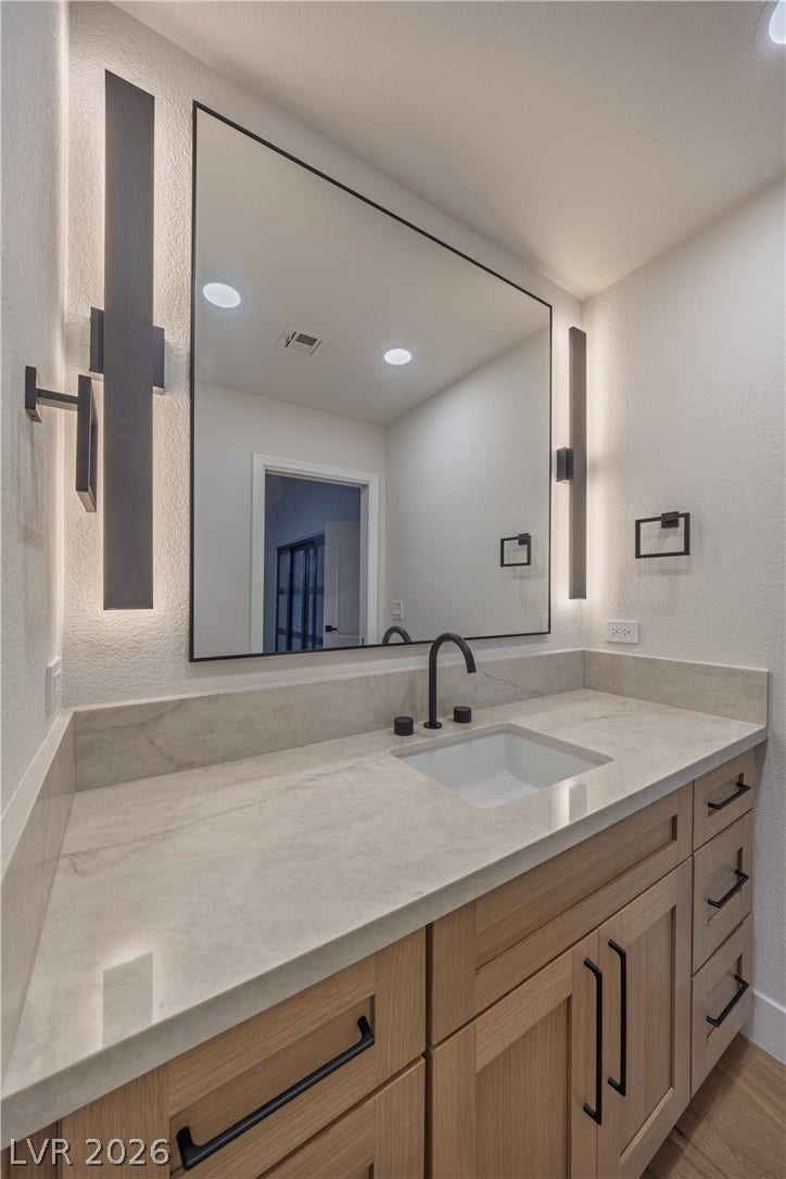 8800 Lusso Court, Las Vegas, NV 89134 Bathroom with a textured wall and vanity
