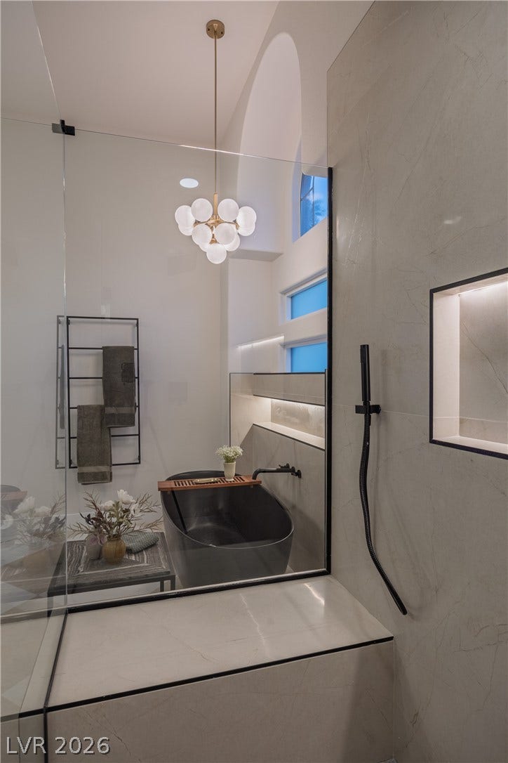 8800 Lusso Court, Las Vegas, NV 89134 Bathroom with hanging lights and a shower