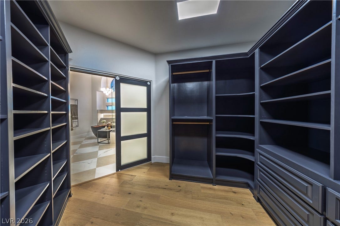 8800 Lusso Court, Las Vegas, NV 89134 Walk in closet with light wood-style flooring and a chandelier