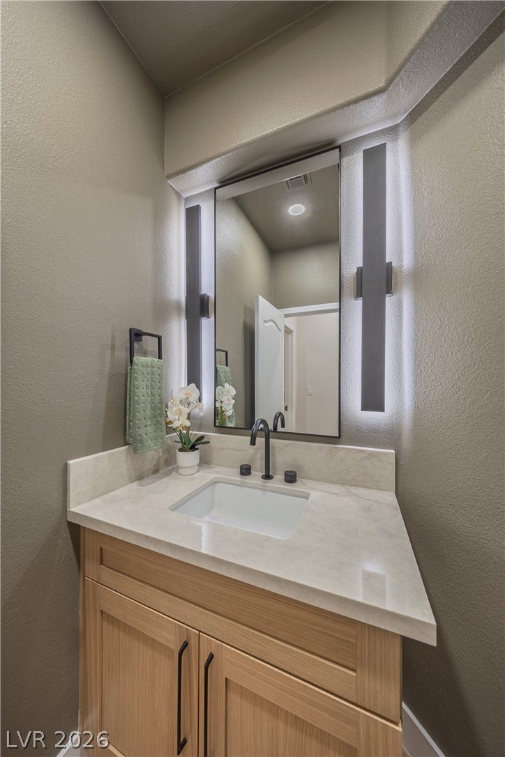 8800 Lusso Court, Las Vegas, NV 89134 Bathroom featuring a textured wall and vanity