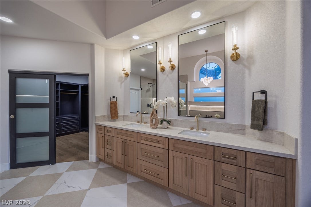 8800 Lusso Court, Las Vegas, NV 89134 Full bathroom with double vanity, a spacious closet, a stall shower, and recessed lighting