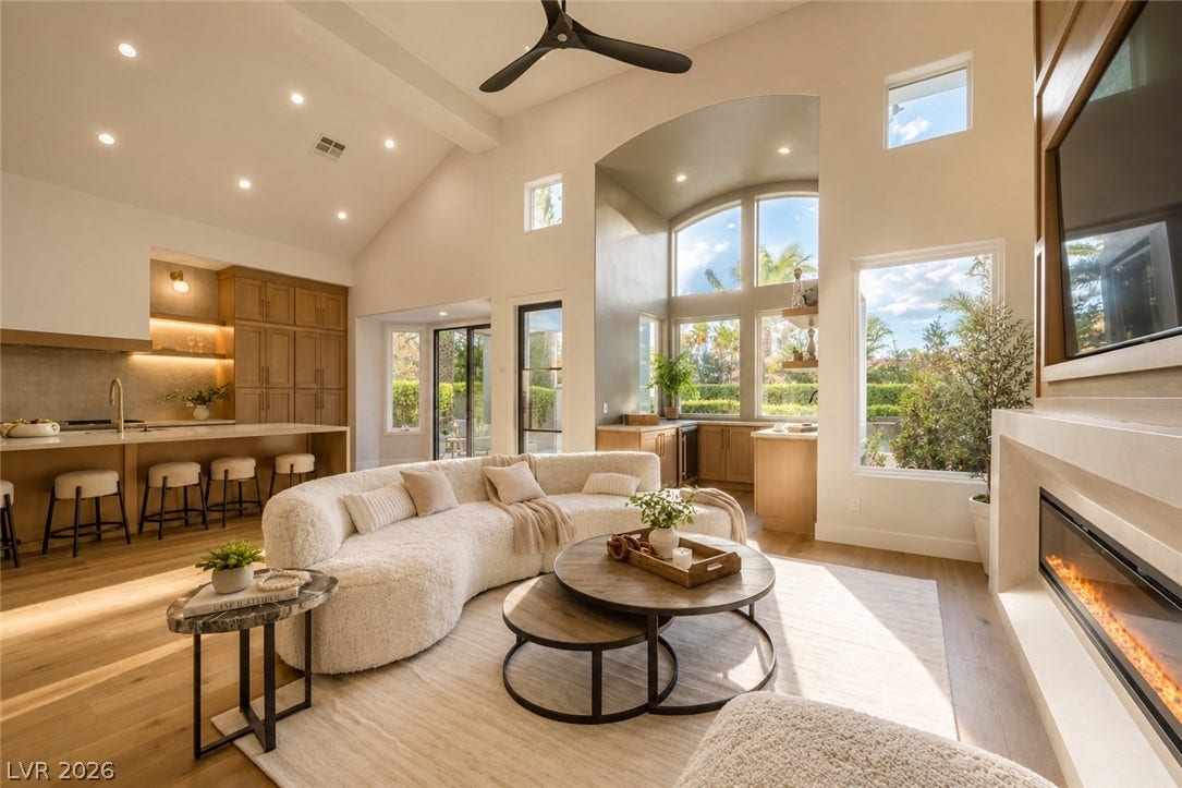 8800 Lusso Court, Las Vegas, NV 89134 Soaring vaulted ceilings and a linear fireplace anchor this open-concept main living space.