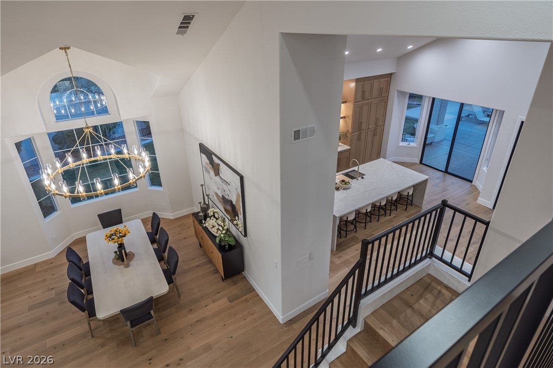8800 Lusso Court, Las Vegas, NV 89134 Staircase featuring a high ceiling, wood finished floors, and a chandelier
