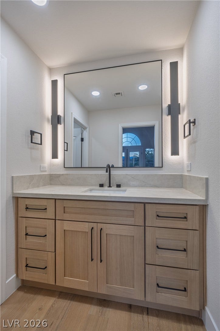 8800 Lusso Court, Las Vegas, NV 89134 Bathroom featuring vanity, a textured wall, light wood-style flooring, and recessed lighting