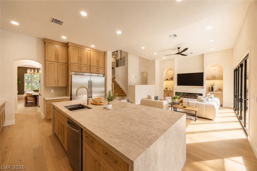 An open concept design seamlessly connects the kitchen with a spacious living area, ideal for entertaining.
