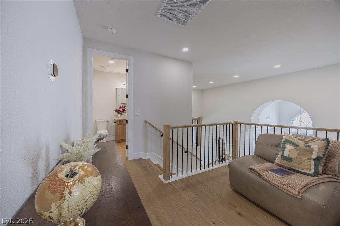 Sitting room featuring light wood finished floors, an upstairs landing, and recessed lighting