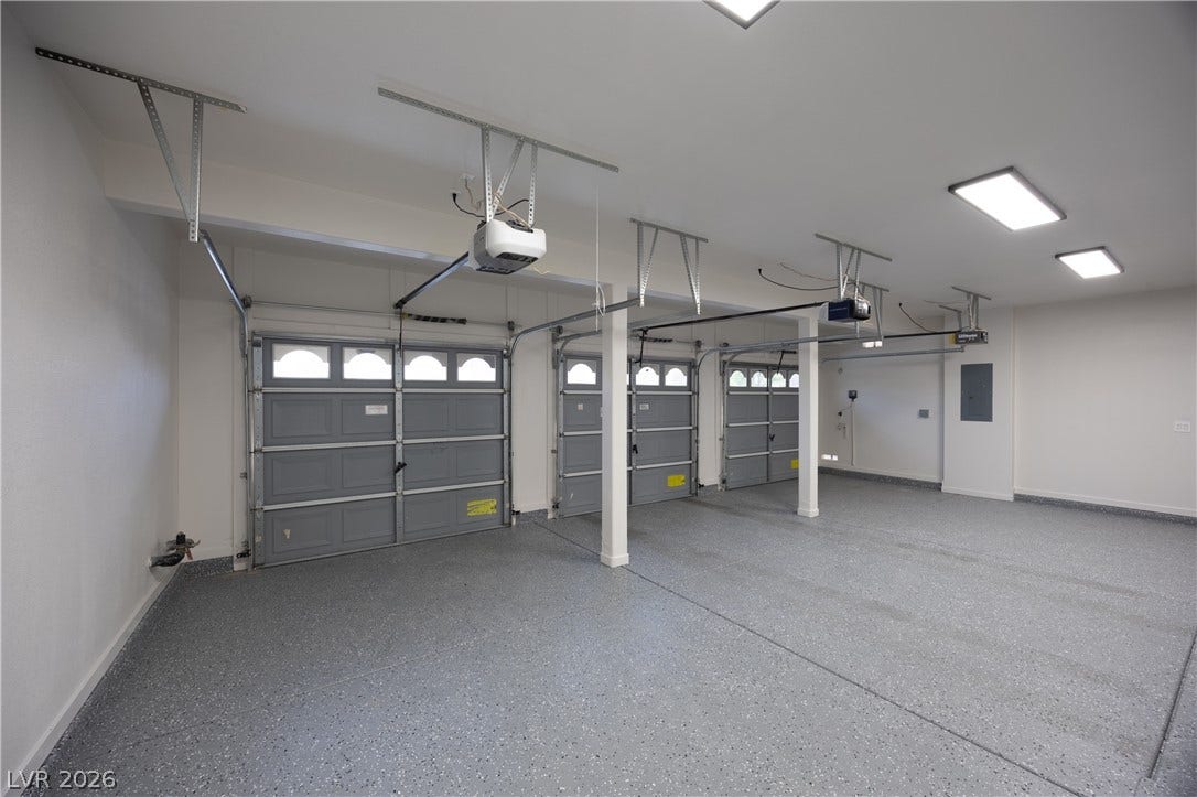 Garage with electric panel and a garage door opener