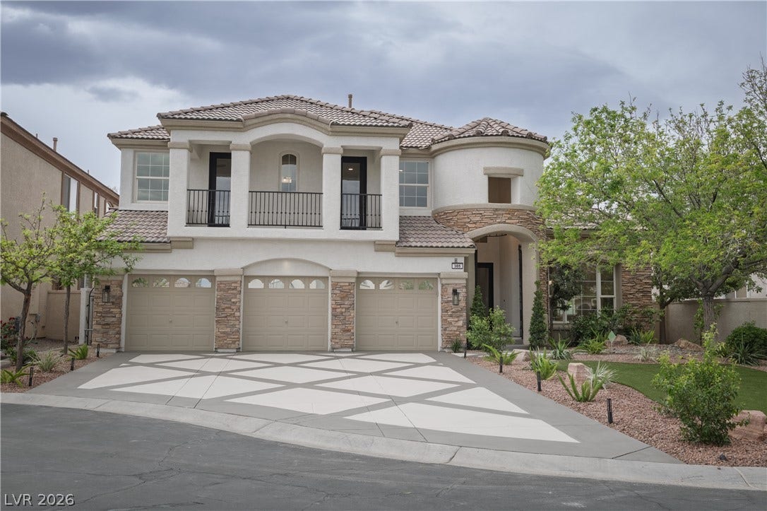 Mediterranean / spanish home featuring stone siding, stucco siding, a balcony, an attached garage, and concrete driveway