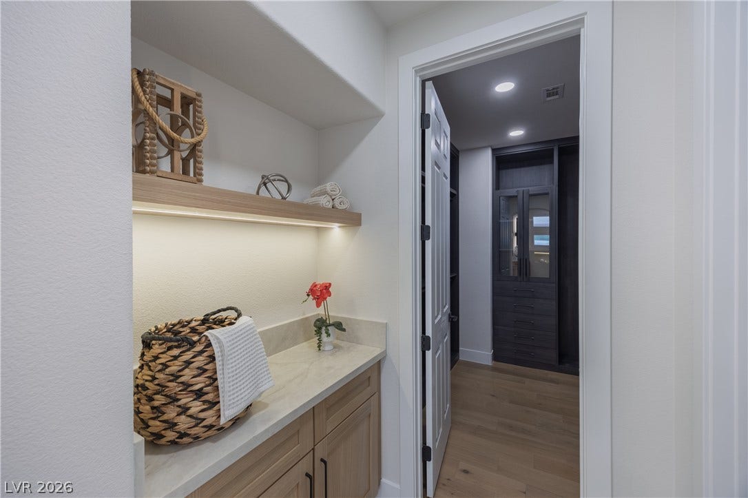 Bar featuring recessed lighting, light wood-type flooring, light stone counters, and light wood finish cabinetry