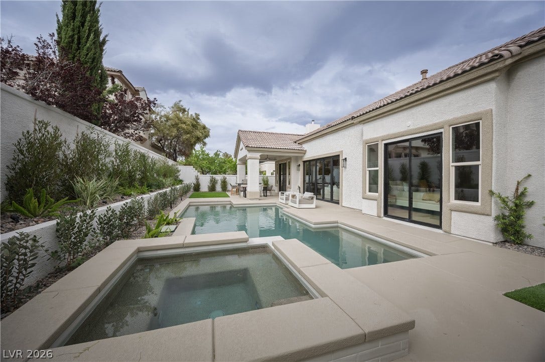 Combined pool / hot tub featuring a patio area and a fenced backyard
