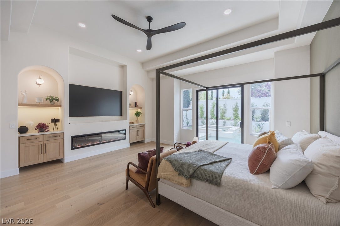 Bedroom featuring access to exterior, light wood-style floors, a ceiling fan, recessed lighting, and a glass covered fireplace