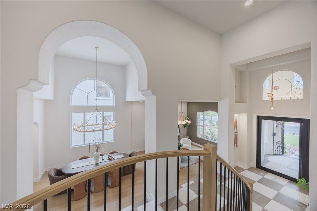 Entryway with hanging lights and a high ceiling