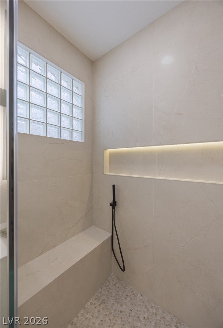 Full bathroom featuring a tile shower