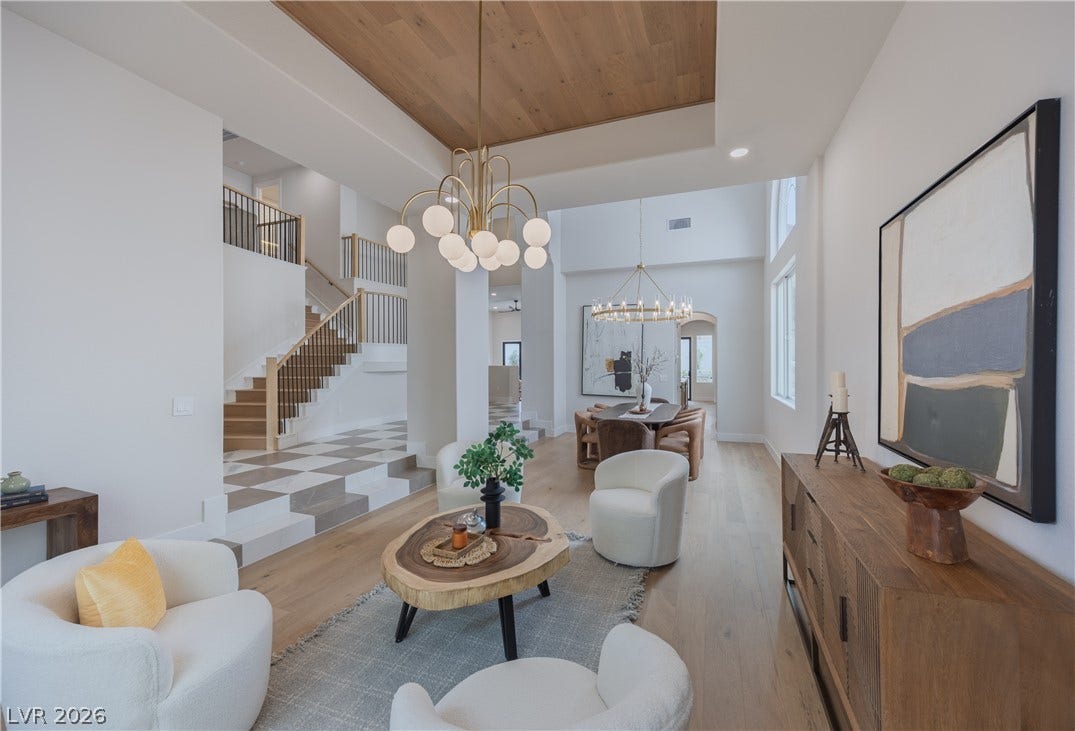 Living room with wood ceiling, hanging lights, light wood-style flooring, and a raised ceiling