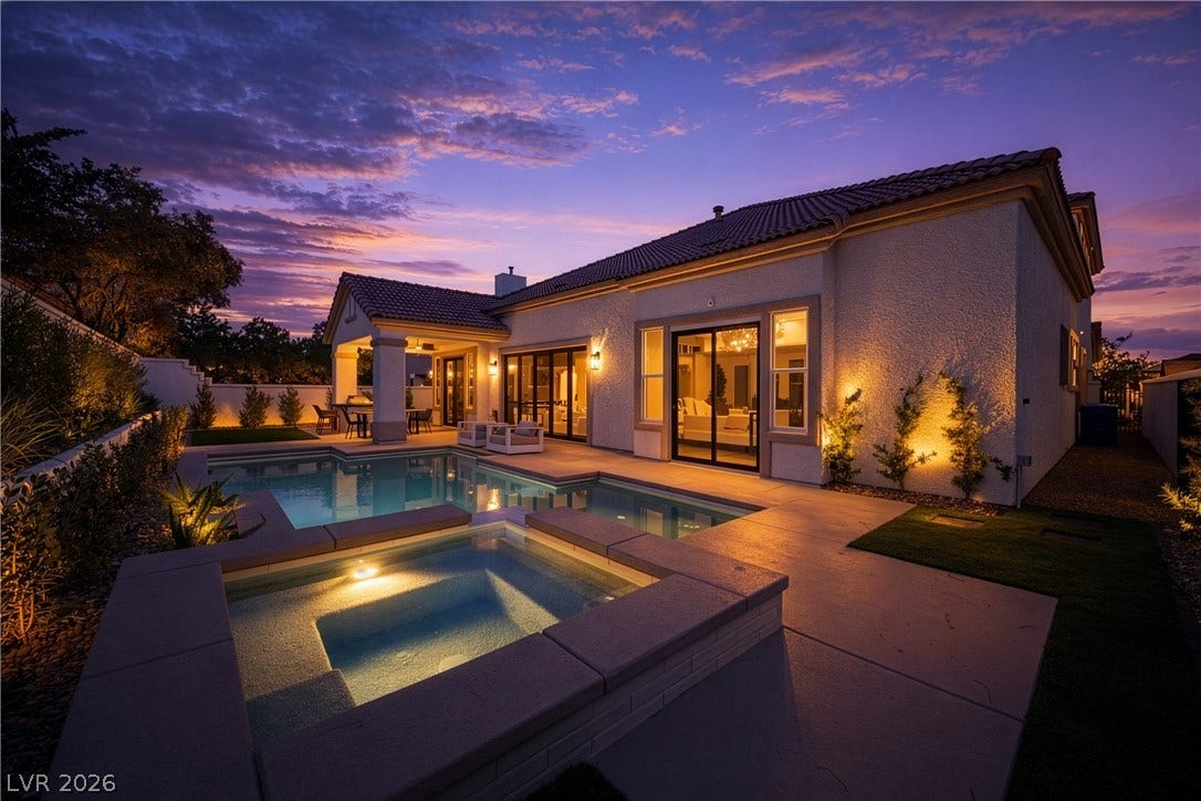 Back of house at dusk featuring a fenced backyard, a tiled roof, a patio, and a chimney
